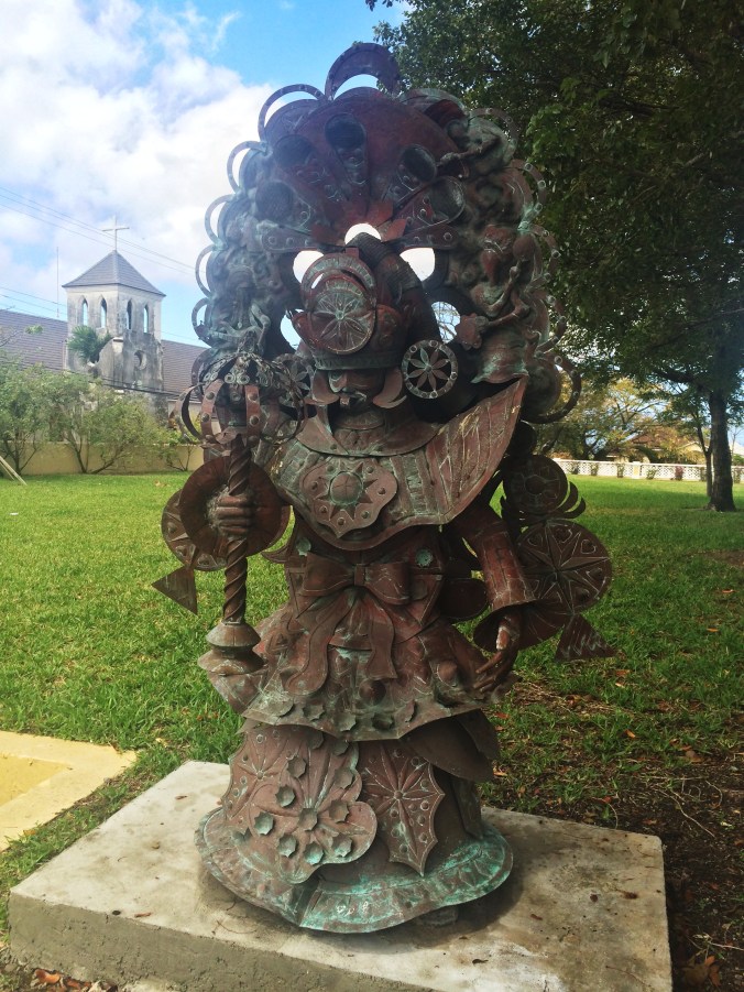 The statue of a Junkanoo costume outside